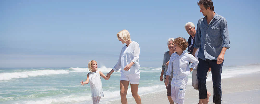 Multigenerational family walking on a beach