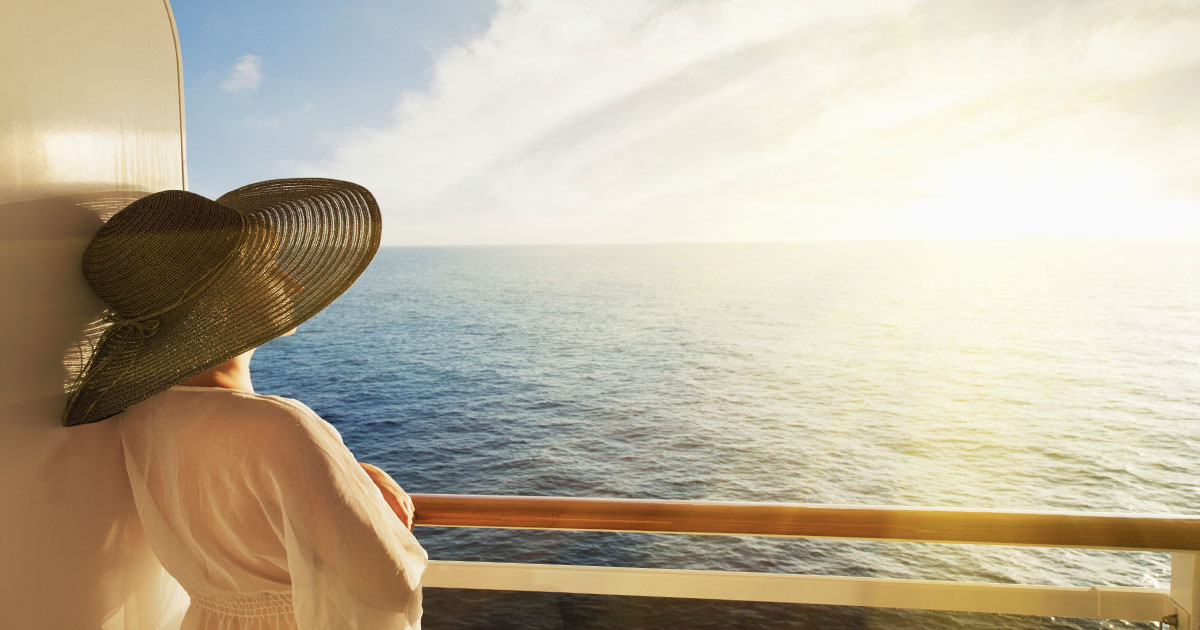 Woman cruise guest looking out the sunset