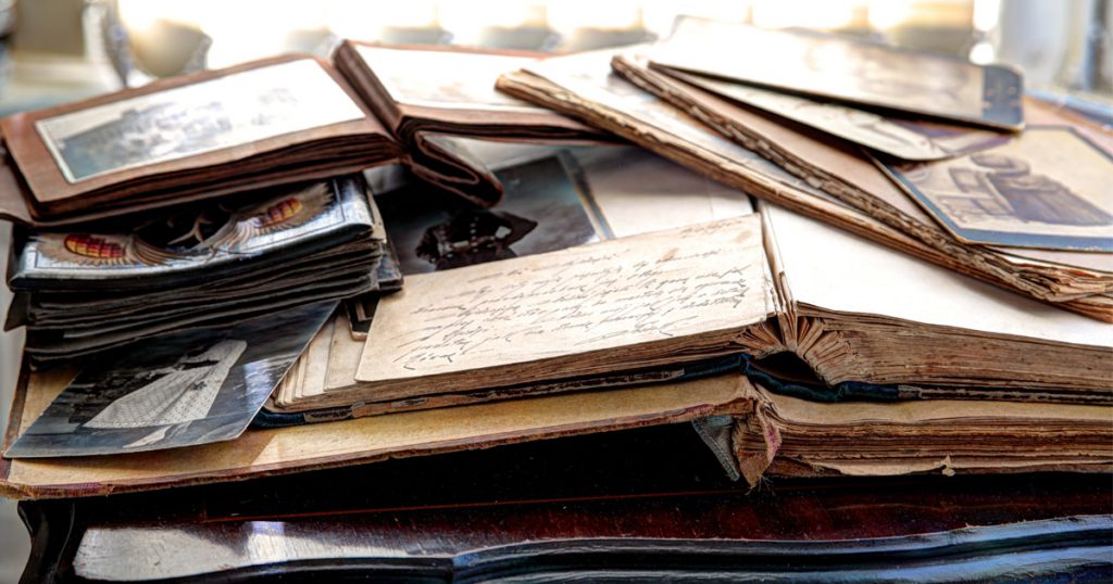 Family albums and old books on vintage table