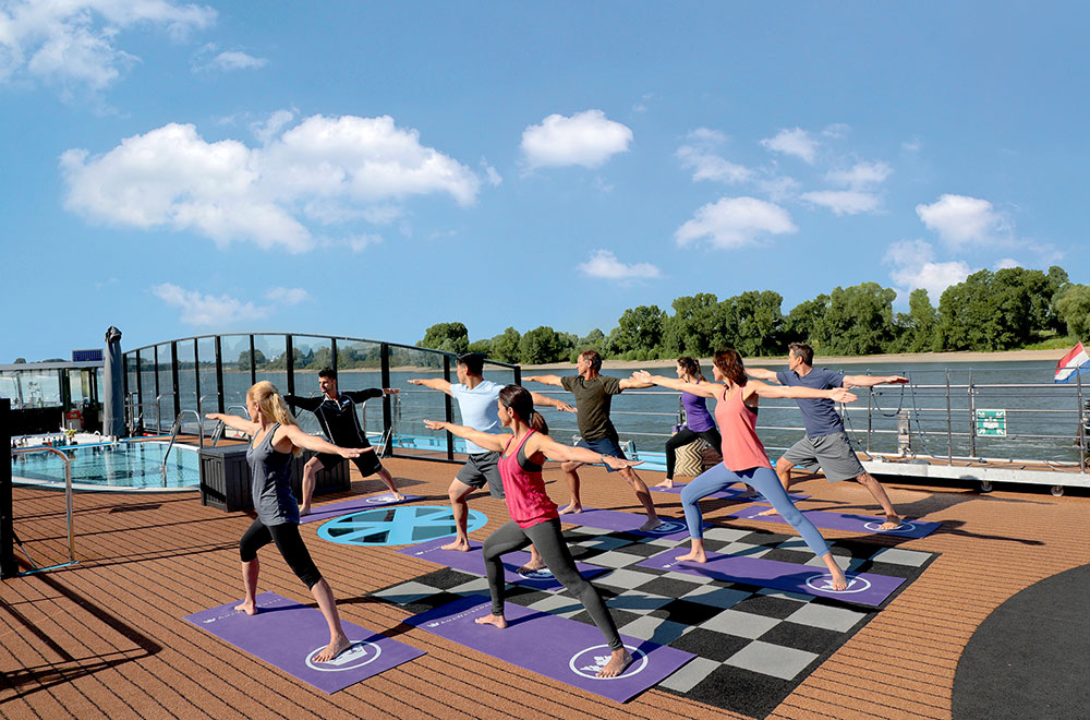 Cruise guests practicing yoga Active travelers in a river cruise