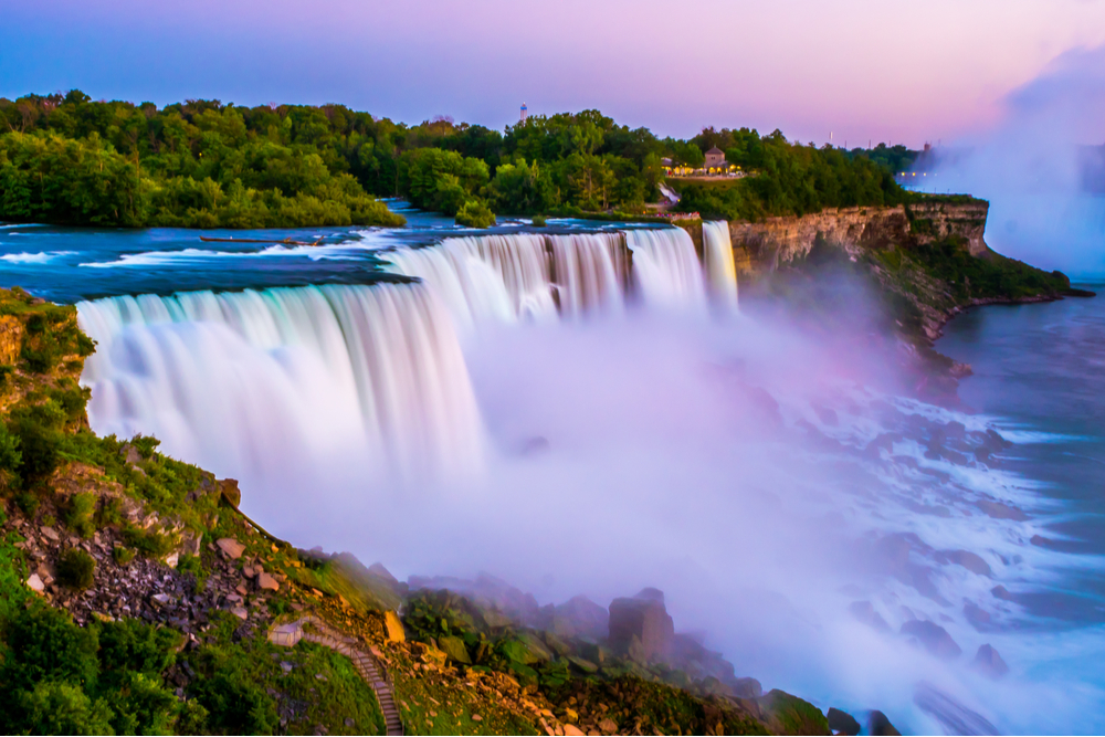 Niagara falls in the summer during beautiful evening, night with clear dark sunset blue sky